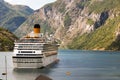 A cruise ship anchored at the Geiranger harbor, Norway Royalty Free Stock Photo