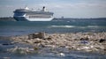 the cruise ship is anchored on a rocky shoreline at high tide