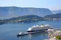 Cruise ship with blue hull and yellow funnel docked in the harbour in the Port of Alesund, Norway. Royalty Free Stock Photo