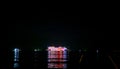 Cruise ship with bright lights sailing in the dark in Andaman sea near Phuket, Thailand. Dinner Cruise Ship Royalty Free Stock Photo