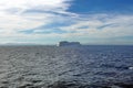 Cruise ship passing in front of Cuba, in the distance, seen across the Caribbean Sea