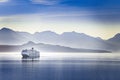 A cruise ship cruising a fjord in Alaska on a summer evening Royalty Free Stock Photo