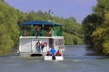 Danube River - landmark attraction in Romania. Cruise ship with tourists in natural reserve of the Danube Delta