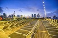 Cruise ship deck chairs at night with city view on the background. Holiday and vacation concept Royalty Free Stock Photo