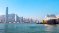 Cruise ship dock embarkment Port Ocean Terminal in Victoria Harbour and Hong Kong Skyline Cityscape at sunrise from Tsim Sha Tsui Royalty Free Stock Photo
