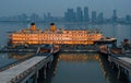 Cruise ship docked adjacent to a pier, with towering skyscrapers in the background in Wuhan, China Royalty Free Stock Photo