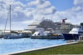 A cruise ship docked behind the local boats at the Oranjestad Harbour, Aruba, Caribbean Sea Royalty Free Stock Photo