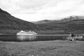 Cruise ship in fjord of Sejdisfjordur, Iceland. Ocean liner in sea harbor on mountain landscape. Cruising for pleasure Royalty Free Stock Photo