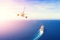 Cruise ship goes into the open sea, plane flies into the sky horizon in the evening at sunset. Travel summer vacation concept Royalty Free Stock Photo