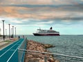 Cruise ship going to port at sea and on pier people walk urban lifestyle blue cloudy sky nature background