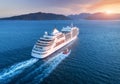 Aerial view of beautiful large white ship at sunset