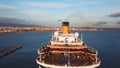 Cruise ship at harbor. Stock. Aerial view of beautiful large white ship at sunset. Colorful landscape with boats in