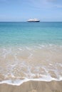 Cruise ship on the horizon of tropical beach Royalty Free Stock Photo