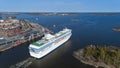 The cruise ship leaves the Helsinki port and enters the Baltic Sea through a narrow strait. Beautiful sunny spring panorama. Royalty Free Stock Photo