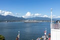 Cruise ship is leaving Canada Place pier and heading towards the Lions Gate Bridge. North Vancouver in the background Royalty Free Stock Photo
