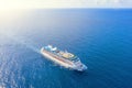 Cruise ship liner sails in the blue sea leaving a plume on the surface of the water seascape. Aerial view The concept of sea Royalty Free Stock Photo