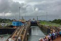 A cruise ship with the passengers on the bow watching ships going through the Panama Canal Royalty Free Stock Photo