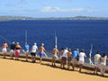 Cruise ship passengers on the deck arriving in Caribbean port