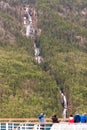 Cruise ship passengers viewing a waterfall in Alaska Royalty Free Stock Photo