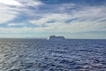 Cruise ship passing in front of Cuba, in the distance, seen across the Caribbean Sea