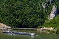 Cruise ship passing by rock sculpture of Decebalus in Danube gorge