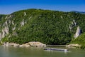 Cruise ship passing by rock sculpture of Decebalus in Danube gorge Royalty Free Stock Photo
