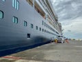 A cruise ship at a port taking on supplies for the next leg of their passage Royalty Free Stock Photo