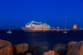 Cruise ship at port between two sailing yachts dusk Royalty Free Stock Photo