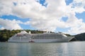 Cruise ship at seacoast in Fowey, United Kingdom. Ocean liner in sea on cloudy sky. Summer vacation on tropical island Royalty Free Stock Photo