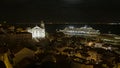 Cruise ship on Tagus river in front of Alfama district, with illuminated Santa Estevao church in Lisbon at night Royalty Free Stock Photo