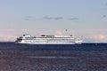 A cruise ship with tourists is sailing along the large Onega Lake.