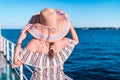 Rear view of young woman on ship deck looking at horizon over sea. Summer vacation and travel concept Royalty Free Stock Photo