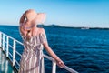 Cruise ship vacation woman enjoying travel vacation at sea. Free carefree happy girl looking at ocean and holding sunhat Royalty Free Stock Photo