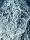 Cruise ship wake on a beautiful sunny day with white clouds and blue seas on the Atlantic Ocean