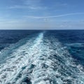 Cruise ship wake on a beautiful sunny day with white clouds Royalty Free Stock Photo