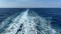 Cruise ship wake on a beautiful sunny day with white clouds and blue seas on the Atlantic Ocean Royalty Free Stock Photo