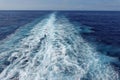 Cruise ship wake on a beautiful sunny day with white clouds and blue seas on the Atlantic Ocean