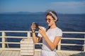 Cruise ship woman using mobile phone on travel vacation at ocean. Girl texting sms on wifi on tropical holidays