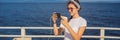 Cruise ship woman using mobile phone on travel vacation at ocean. Girl texting sms on wifi on tropical holidays Royalty Free Stock Photo