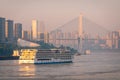 A cruise ship on the Yangtze River under the shining glow of the sunrise passes Cuntan Port Royalty Free Stock Photo