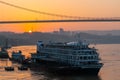 A cruise ship on the Yangtze River under the shining glow of the sunrise passes Cuntan Port Royalty Free Stock Photo