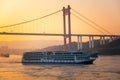 A cruise ship on the Yangtze River under the shining glow of the sunrise passes Cuntan Port Royalty Free Stock Photo