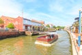 Cruise tour boat sails on the Malacca River in Malacca, Malaysia.