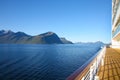 Cruise towards Geiranger fjord on a beautiful calm day with views of the Norwegian mountains from the deck of the ship, Norway.