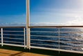 Cruise wooden deck with metal barrier in sunset rays light at At Royalty Free Stock Photo