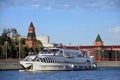 A cruise yacht sails along Moscow Kremlin. Color photo.