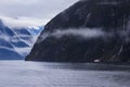 cruising boat beside mountain at milfordsound fiordland national park southland new zealand Royalty Free Stock Photo