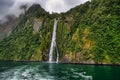 Cruising in a large catamaran past Mitre Peak and waterfalls through the Milford Sound