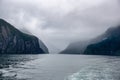 Cruising in a large catamaran past Mitre Peak and many waterfalls through the Milford Sound