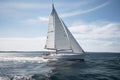 cruising sailboat with white sails billowing in the wind Royalty Free Stock Photo